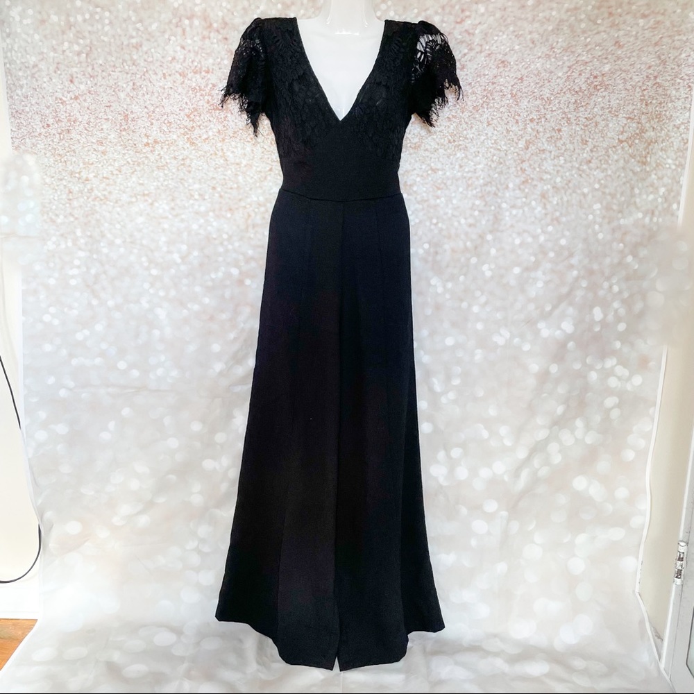 Black flared jumpsuit with mesh cap sleeves